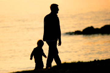 father son beach walking